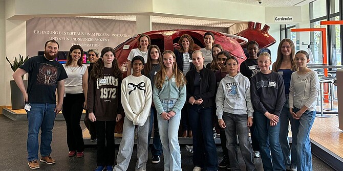 Goup of girls infront of a model of the heart at Girls' Day